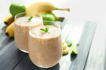 Fresh tasty fruit smoothie in glasses on table