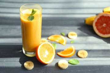 Glass with fresh tasty fruit smoothie on table