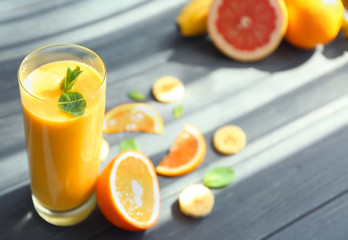 Glass with fresh tasty fruit smoothie on table