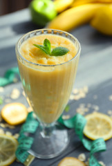 Glass with fresh tasty fruit smoothie on table