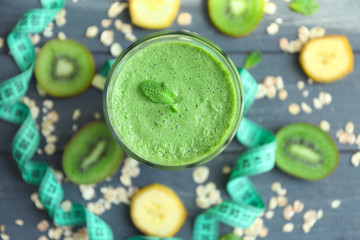 Glass with fresh tasty fruit smoothie on table