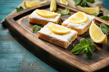 Delicious lemon pie bars on wooden rustic background