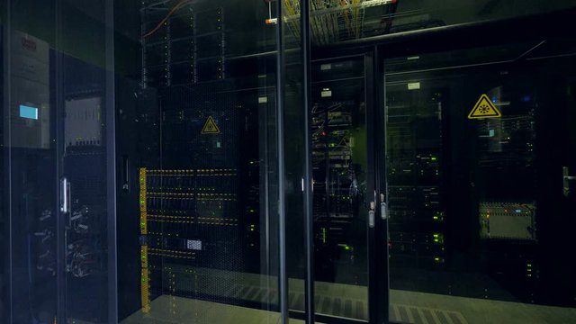 Closed glass doors into a data center room. 
