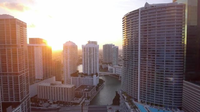 Great Aerial shot through buildings and water in Downtown Miami during sunset