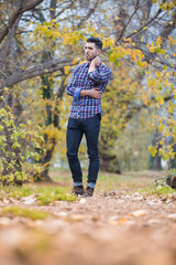 Handsome desolate man in the park. Autumn scenery