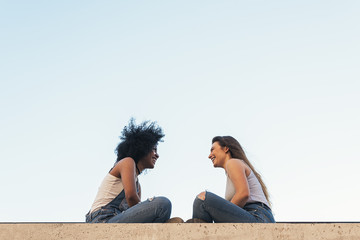 Beautiful women chatting in the street.