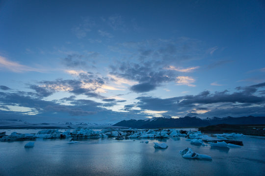 Iceland - Night over glacier lagoon joekulsarlon with many ice floes swimming