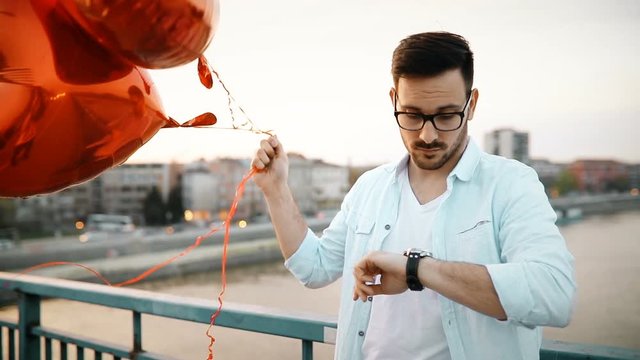 Sad man waiting for date on valentine date
