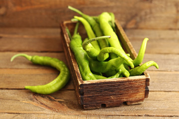 Green peppers on wooden background