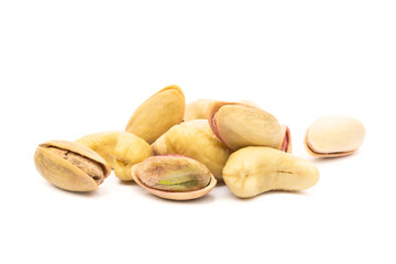 Pile of roasted pistachios and cashew isolated on white background