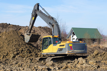 Obraz premium Yellow crawler excavator on work