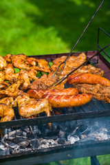 BBQ in the garden - selection of meat on flaming grill
