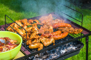 BBQ in the garden - selection of meat on flaming grill