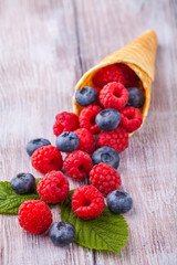 Sugar waffle cone with forest berries Vertically