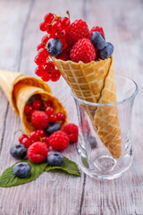 Sugar waffle cone with forest berries Vertically