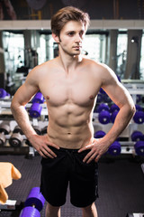Fototapeta na wymiar Muscular man working out in gym doing exercises at triceps, strong male naked torso abs. Fitness