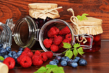 blueberries and raspberries in jars for the winter tea