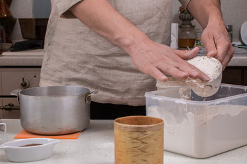 Making dough by male hands at home in kitchen