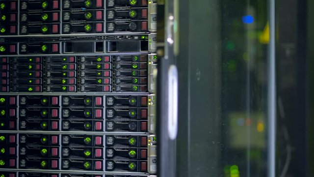 A server cabinet filled full with hard disks. 