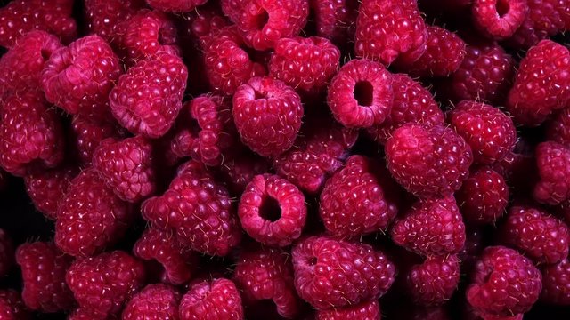 Top view of fresh juicy raspberries rotating in 4K
