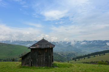 Obraz premium Warehouse for hay, against the background of rainy sky. 