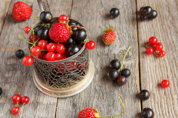 Fresh berries. Various summer berries in a bowl on rustic wooden table.