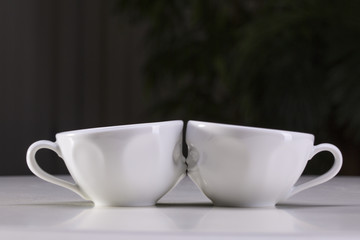 Fototapeta premium Two white cups on a gray background. I love uou.