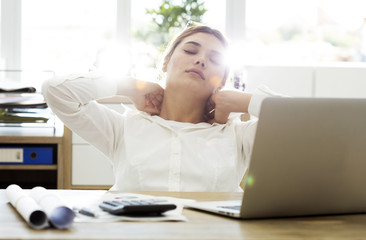 Tired businesswoman holding her nape