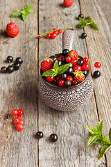 Fresh berries. Various summer berries in a bowl on rustic wooden table.
