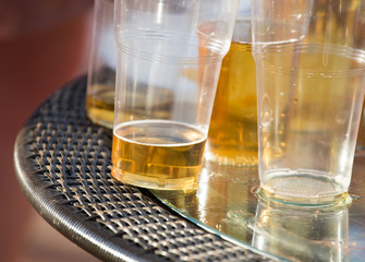 Beer in a plastic glass on the table