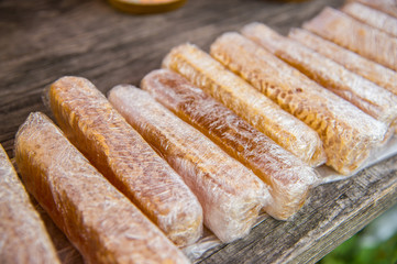 Honey with honeycombs packed in plastic wraps