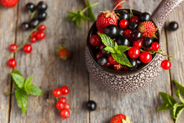 Fresh berries. Various summer berries in a bowl on rustic wooden table.