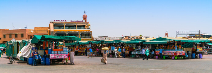 Marrakech, Morocca May 18 2017: Tourists and locals shopping on the Jamma El-Fna square in the...