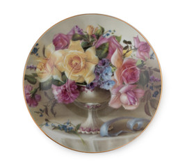Vintage English porcelain saucer with rich floral pattern isolated on white background.