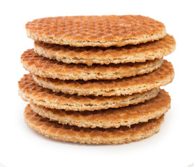 Pile of round dutch waffles with caramel isolated on white background.