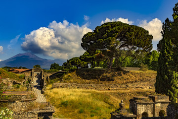 Italy. The excavated ruins of Pompeii (UNESCO World Heritage Site) - Porta Nocera, one of the 8 Pompeii city gate, fragment of the necropolis and Mount Vesuvius in the background