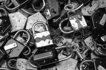 Old rusty locks and keys at flea market. Security, censorship or suppression concept. Black and...