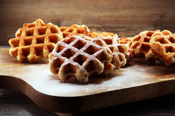 Traditional belgian waffles on brown wooden board
