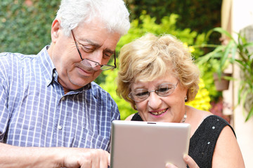 Elderly couple using tablet.