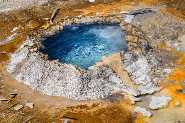 Blue boiling water in a crater. Hot spring, pool in Yellowstone National Park. Closeup of a spring geyser.