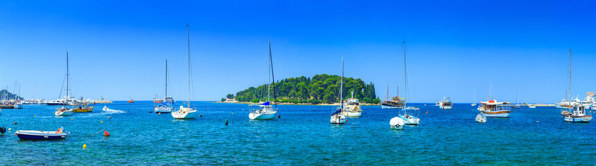 Fototapeta premium Wonderful romantic old town at Adriatic sea. Boats and yachts in harbor at magical summer. Rovinj. Istria. Croatia. Europe.