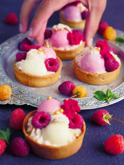 Cakes with strawberries and berries. Raspberry Cakes on dark background. Tasty Raspberry Tarts on a Vintage Plate. Wonderful Sweet Desserts. Mini tarts with Raspberries. Raspberry fruit tart.