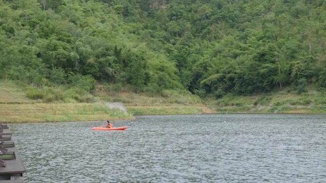 4k video of Young man kayaking on the river and mountain in Kanchanaburi, Thailand