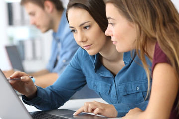 Serious employees working on line at office
