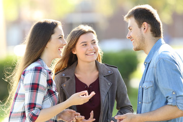 Three friends having a conversation in the street