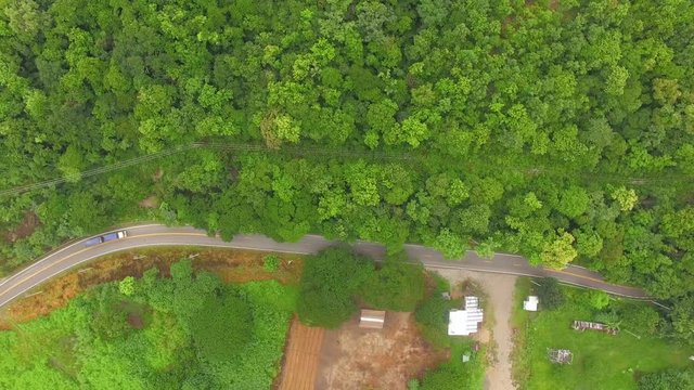 Aerial view of car on road in tropical forest, Shot from drone