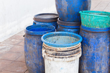 Naklejka premium dirty white and blue garbage bin with copyspace on the left