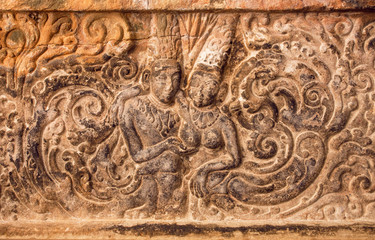 Fototapeta na wymiar Lovers, two historical people - man and woman - on carved wall relief made in circa 7th century. Artwork inside Hindu temple of Aihole, India