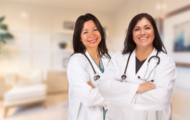 Fototapeta premium Female Hispanic Doctors or Nurses Standing in an Office