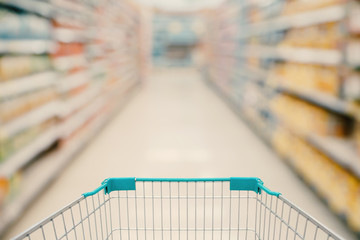 Shopping cart view with Supermarket aisle blurred background